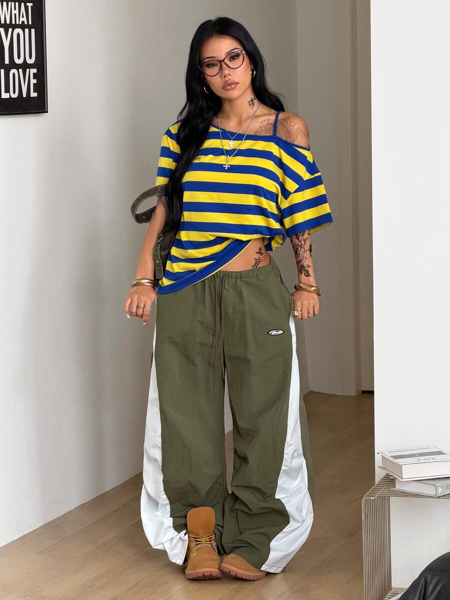 Women's casual loose fit cold shoulder cotton t-shirt with asymmetrical cutout neckline and short sleeves.