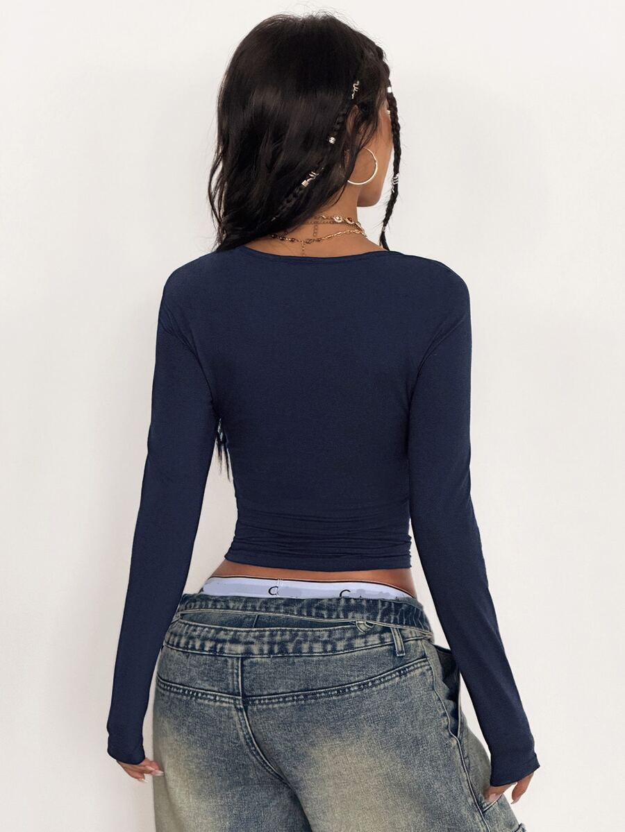 Women's slim fit long sleeve raglan t-shirt with collegiate letter graphic print, round neck, and contrast binding.