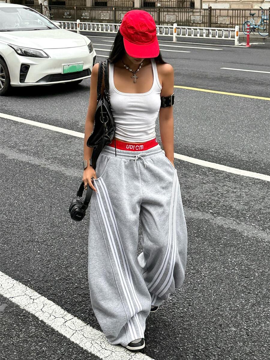Women's casual grey plaid sweatpants featuring an elastic drawstring waistband, side pockets, and a relaxed loose fit.