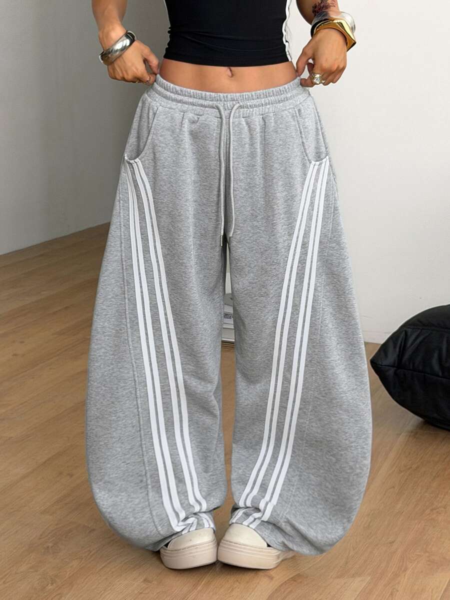 Women's casual grey plaid sweatpants featuring an elastic drawstring waistband, side pockets, and a relaxed loose fit.