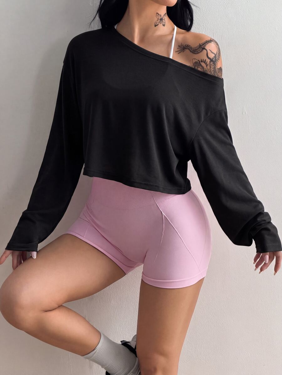 Women's white one shoulder rib-knit crop pullover top featuring an asymmetrical neckline, drop shoulder long sleeves, and a relaxed loose fit for yoga and athleisure wear.