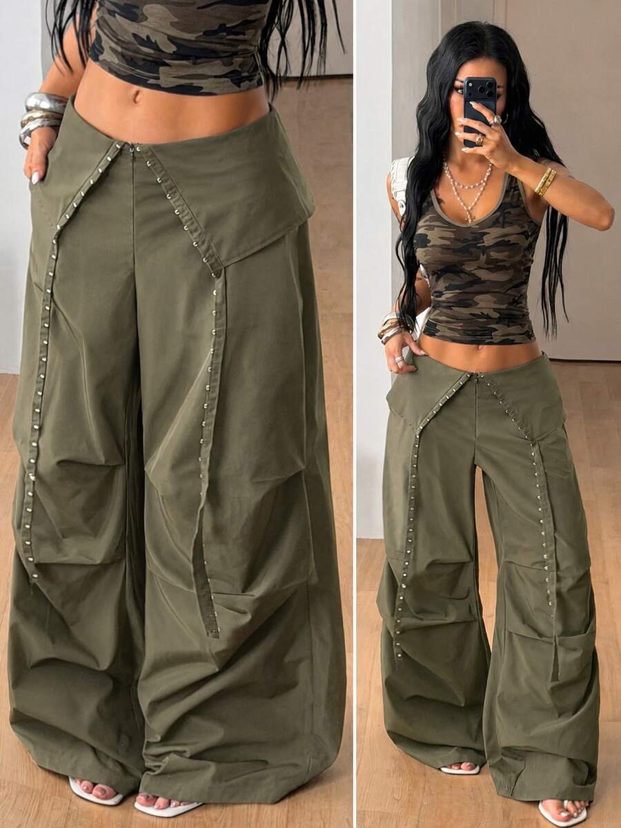 Women's low rise parachute cargo pants featuring a loose straight leg cut, functional pockets, zipper fly, and subtle studded accents.