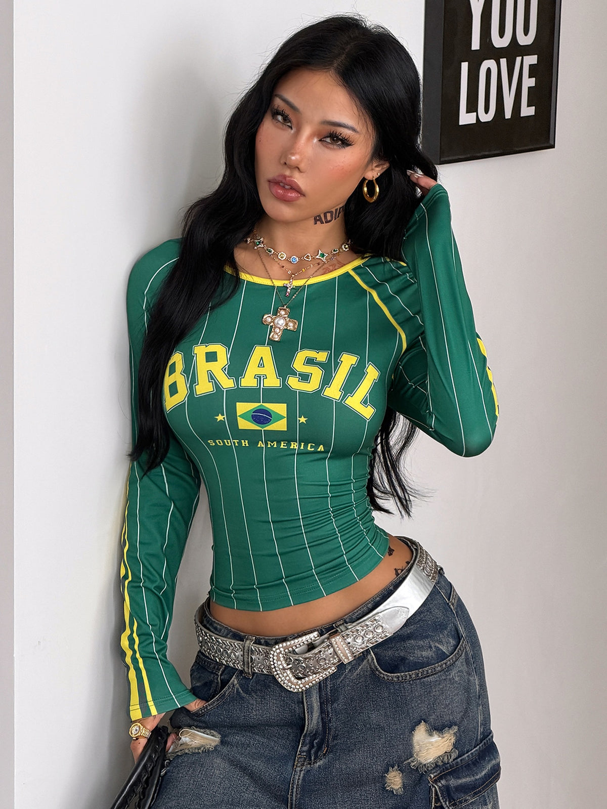 Women's slim fit long sleeve raglan t-shirt with collegiate letter graphic print, round neck, and contrast binding.