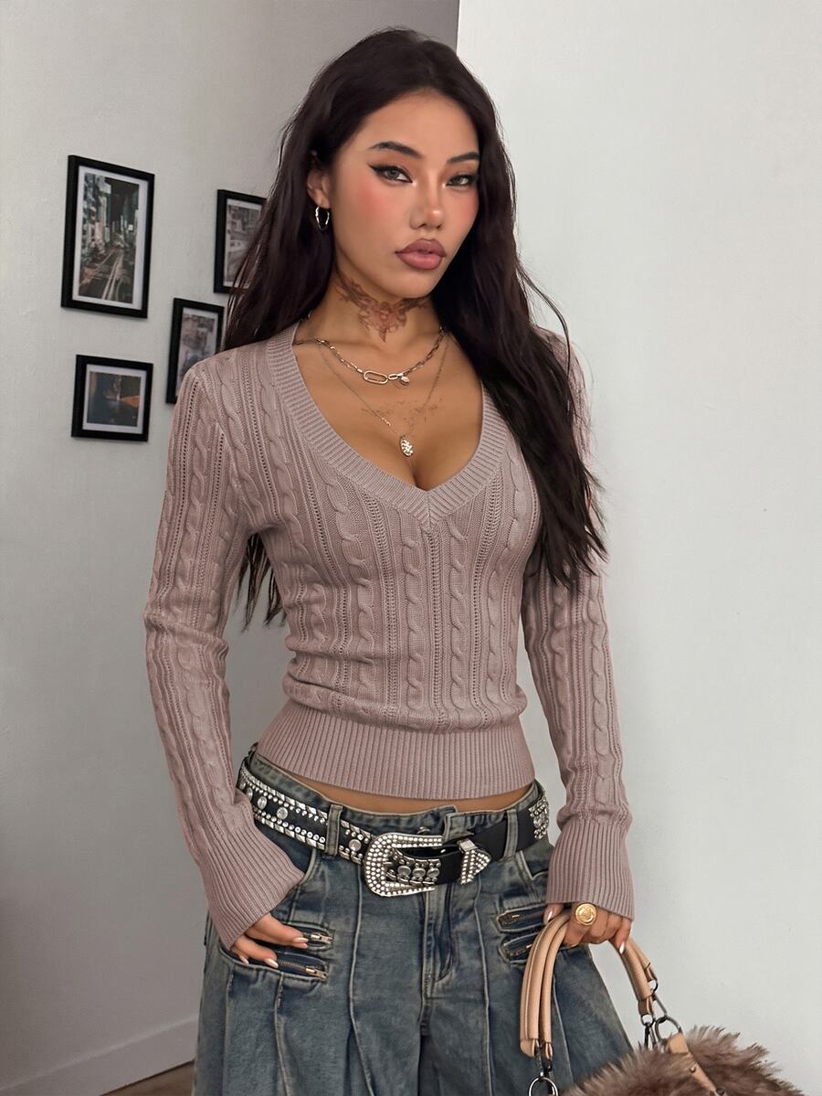 Women's slim fit cable-knit long sleeve sweater featuring a V-neckline and ribbed knit details.