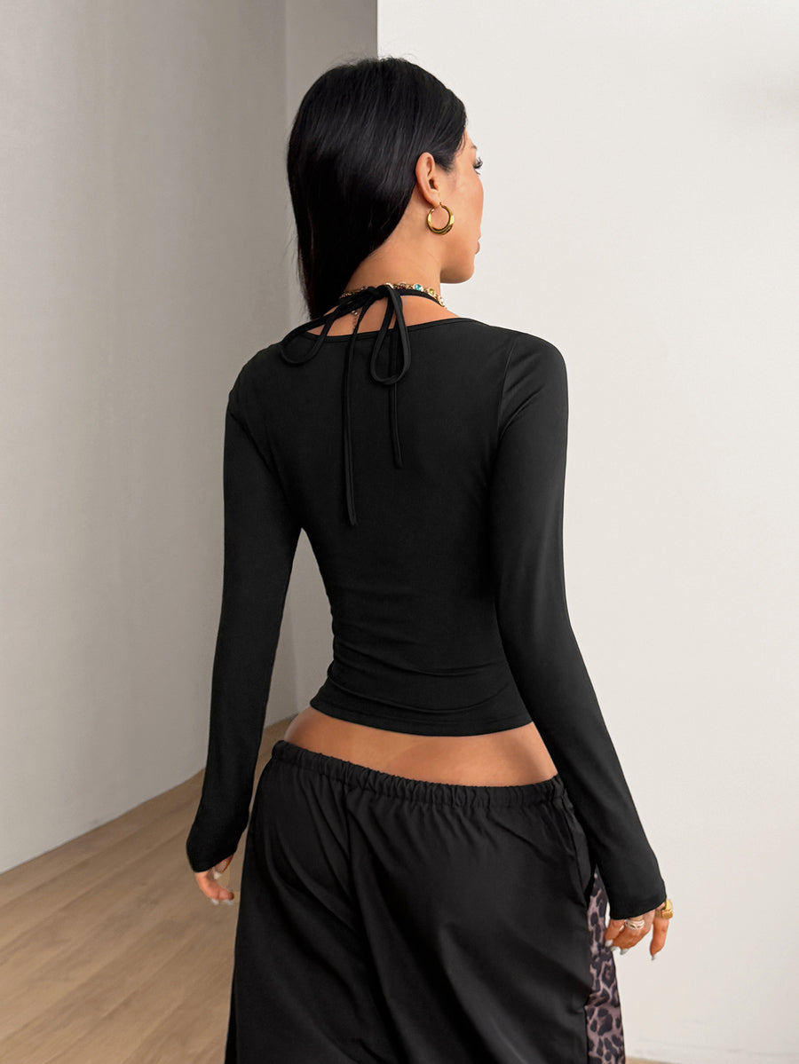 Women's slim fit black halter long sleeve t-shirt with contrast lace detailing and deep v-neckline.