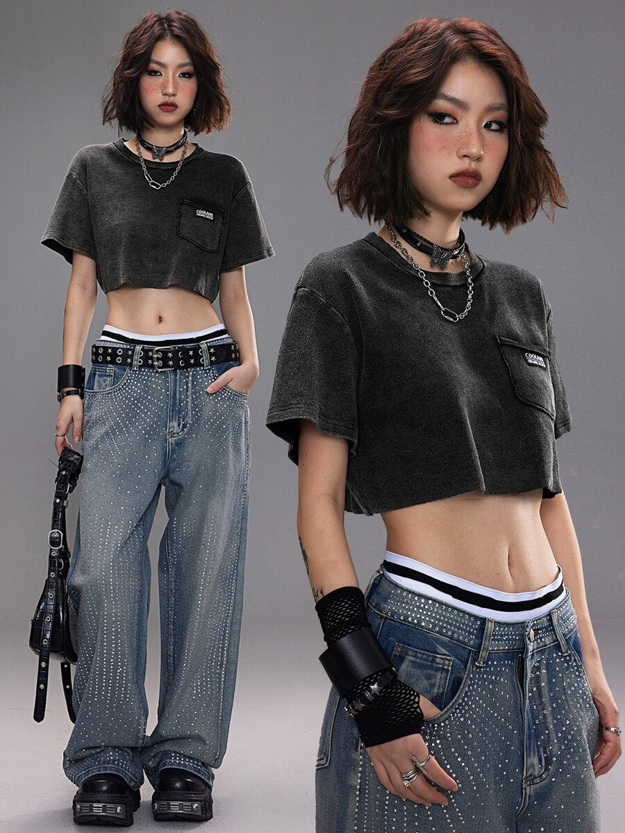 Women's short sleeve crop top with a round neckline and drop shoulder design in black knitted fabric.