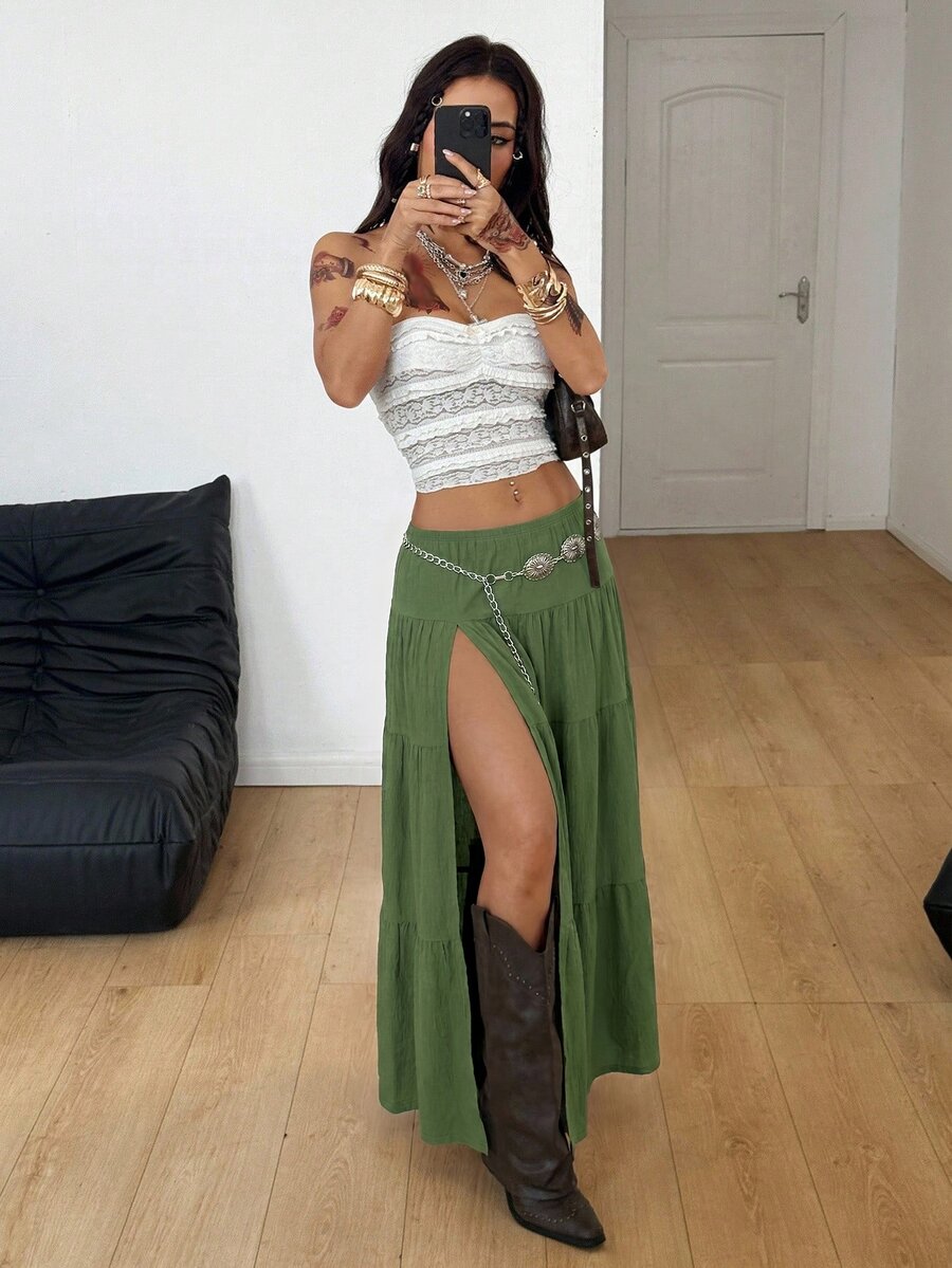 Women's red plaid long skirt featuring a low-rise waist and a side slit in lightweight woven fabric.