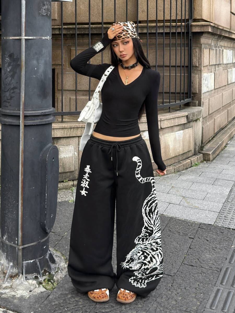 Women's loose fit wide leg graphic sweatpants in light grey with an elastic drawstring waistband