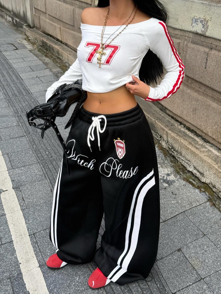 Women's loose fit wide leg graphic sweatpants in light grey with an elastic drawstring waistband