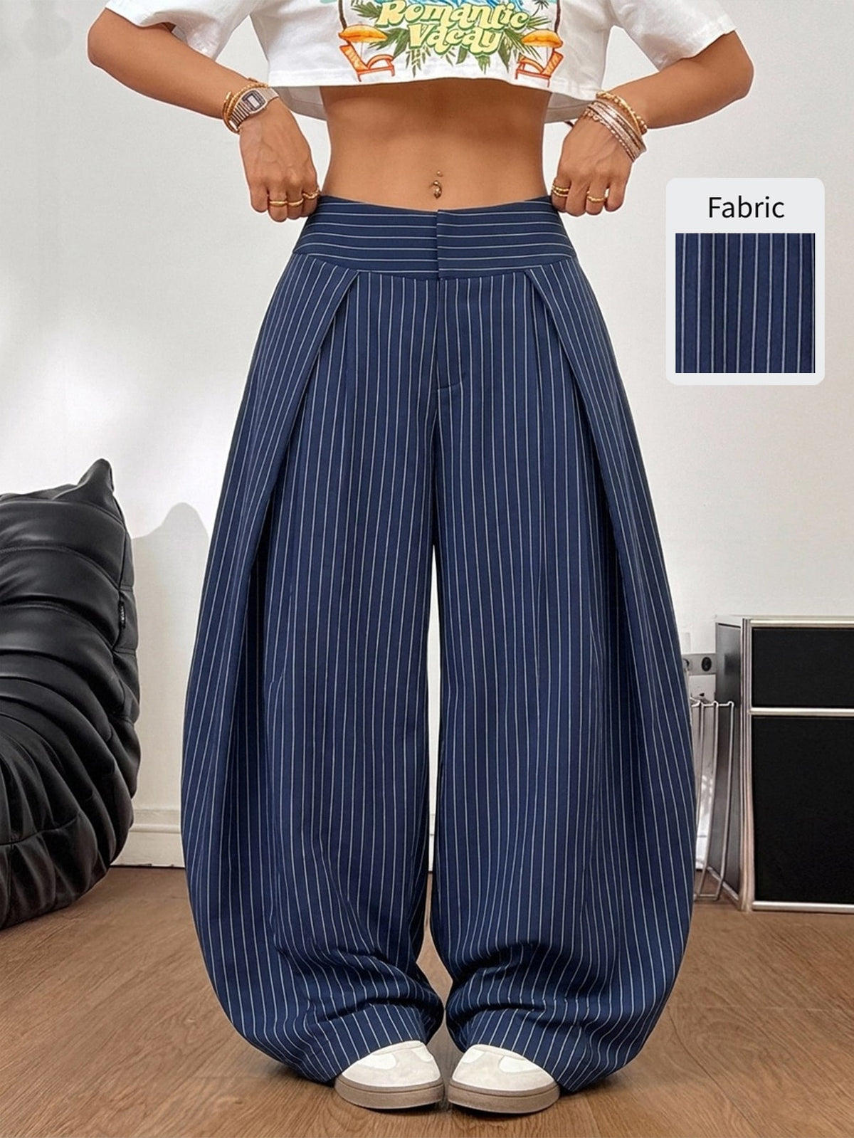 Women's brown striped wide leg pants with a low waist, curved hem, and loose casual fit in woven fabric.