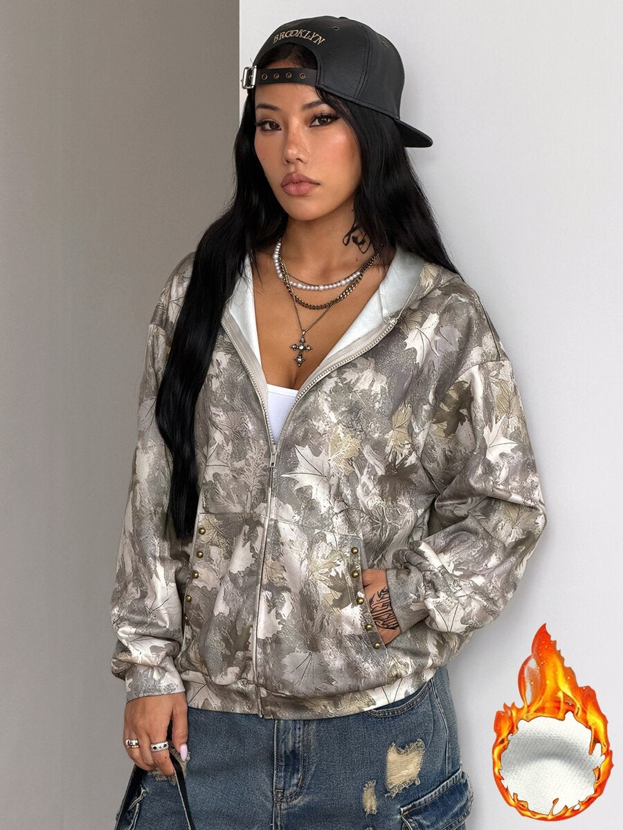 Women's army green camo zip up hoodie with drop shoulder sleeves, front pockets, and drawstring hood