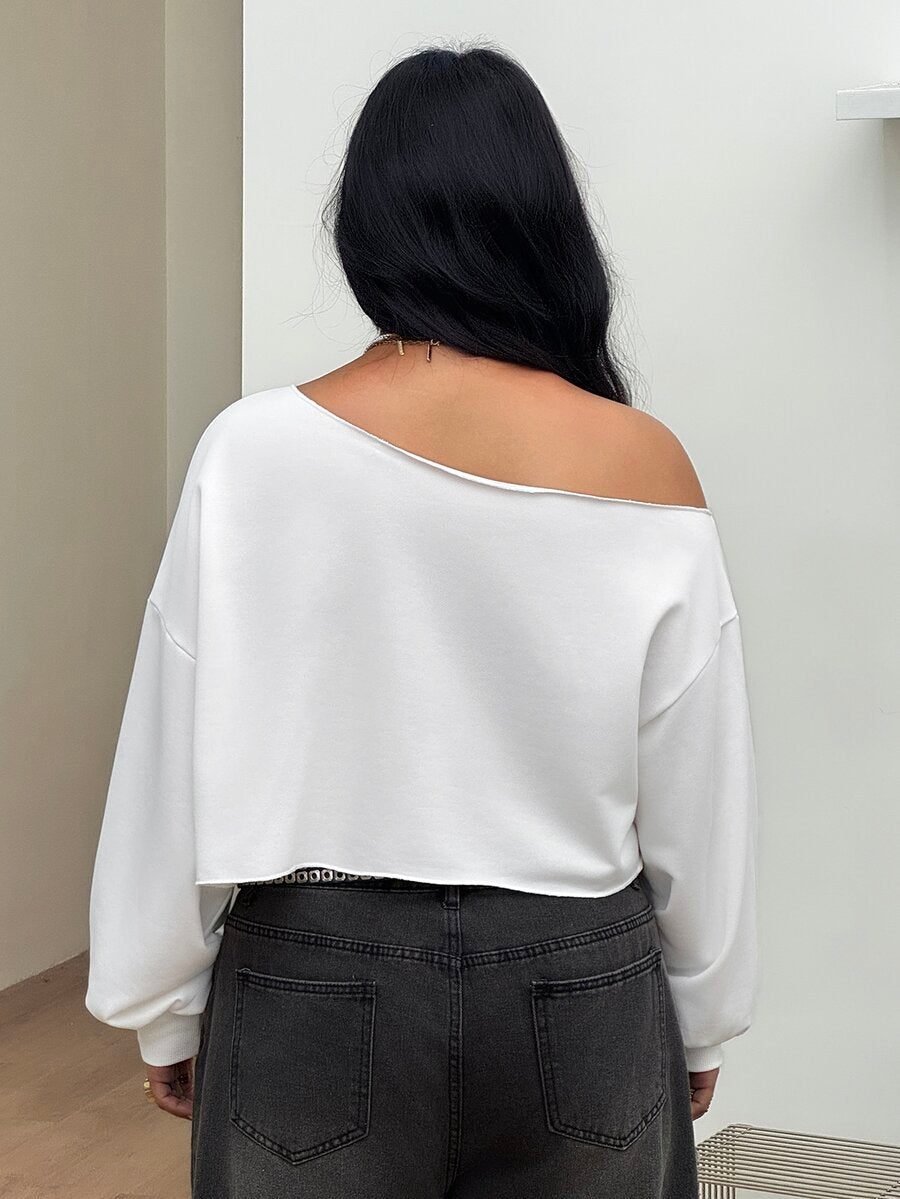 Plus size women's cropped leopard print sweatshirt featuring an asymmetrical neckline and long drop-shoulder sleeves.