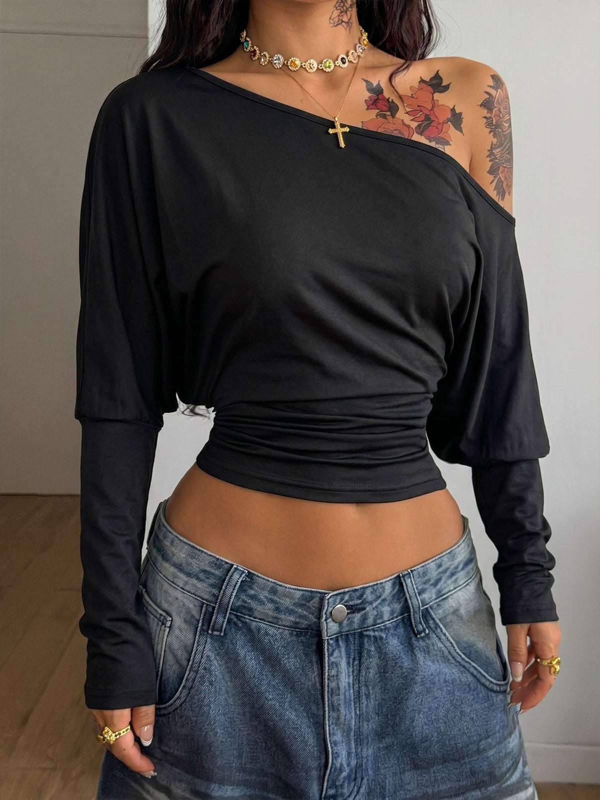Women's black long sleeve t-shirt featuring delicate contrast lace details and a boat neckline in a knitted stretch fabric.