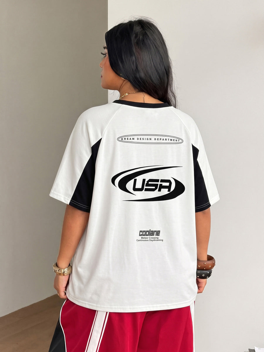 Unisex plus size oversized jersey t-shirt in brown featuring a round neck, short raglan sleeves with contrast binding, and a front letter graphic print.