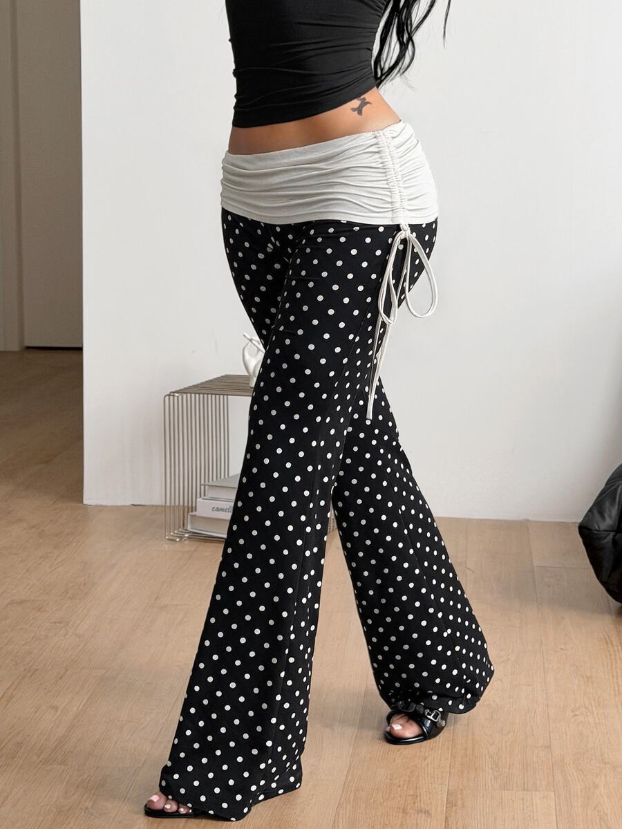 Women's black and white polka dot flare leg pants with side drawstring and ruched details
