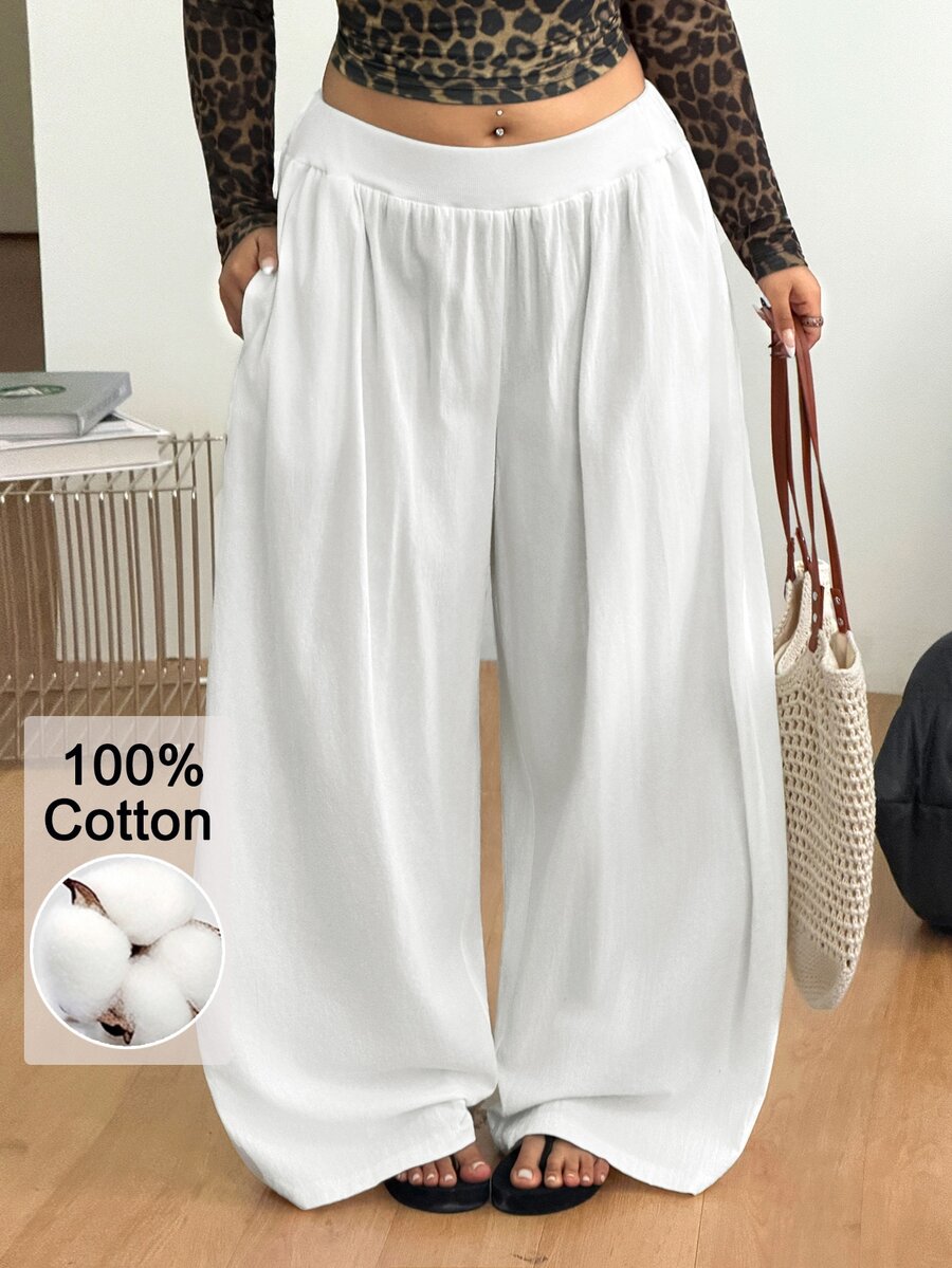 Plus size women's striped loose straight leg cropped pants with pleated detailing and side pockets