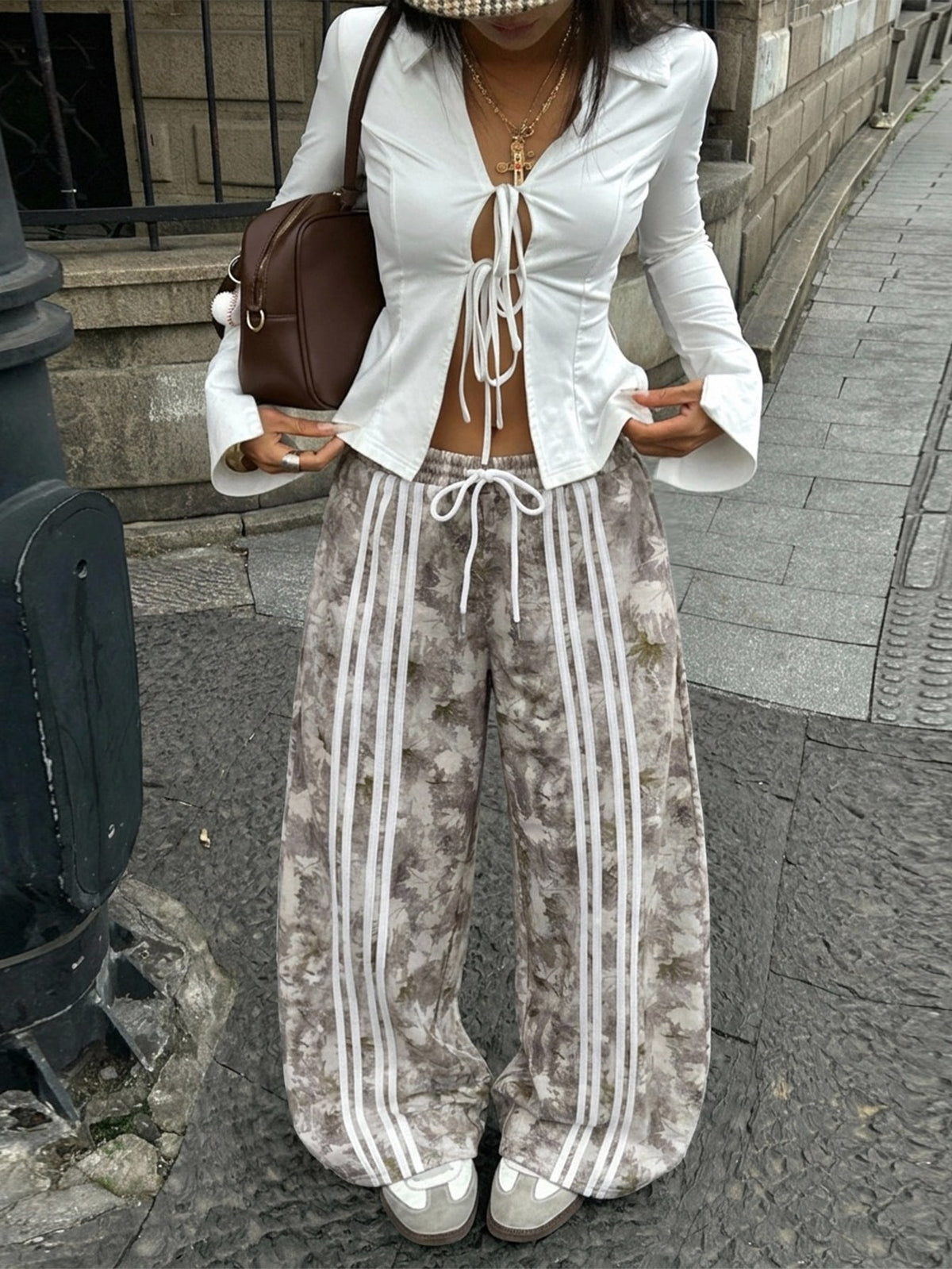 Women's loose fit wide leg graphic sweatpants in light grey with an elastic drawstring waistband
