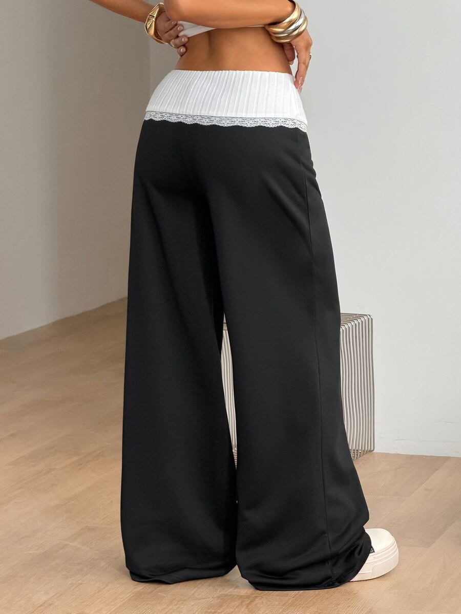 Women's casual straight leg sweatpants featuring a black and white polka dot design with an elastic waistband.