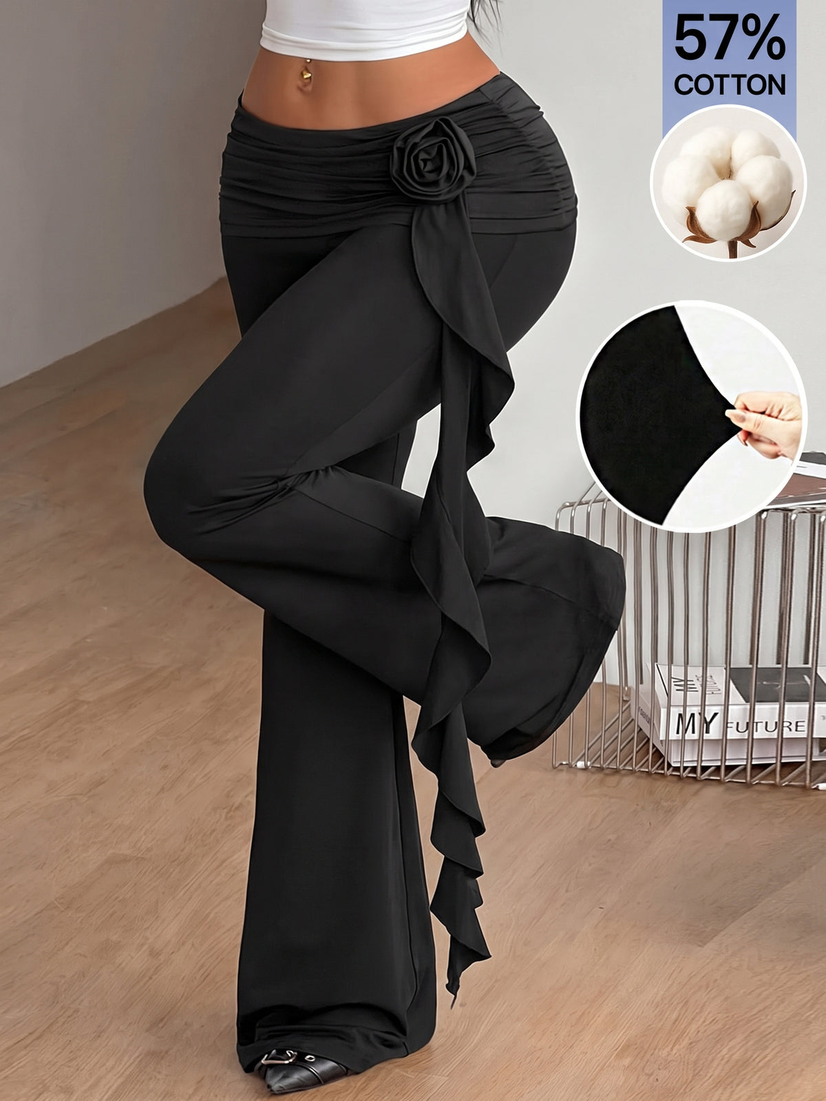 Black low waist flare pants featuring 3D rose and side stripe detailing in stretchy mesh fabric.