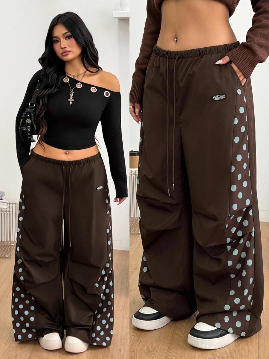 Women's high waist wide leg pants in black featuring leopard print patchwork details and an elastic drawstring waistband.