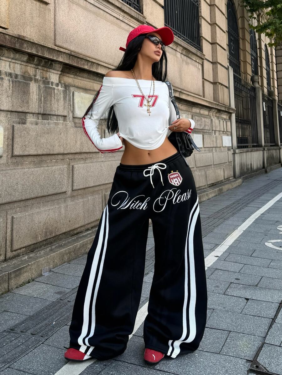 Women's loose fit wide leg graphic sweatpants in light grey with an elastic drawstring waistband