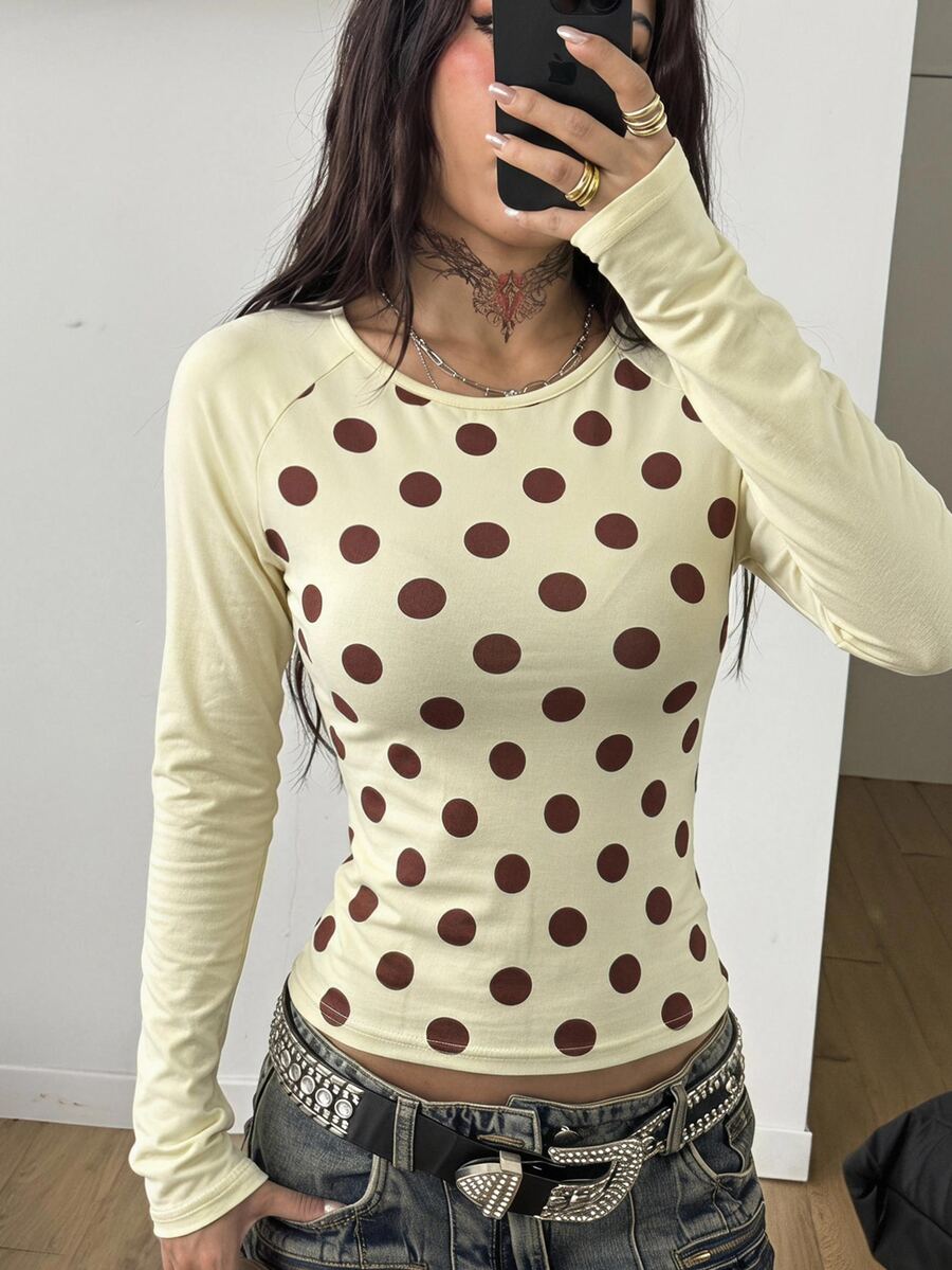 Women's slim fit long sleeve raglan t-shirt with collegiate letter graphic print, round neck, and contrast binding.