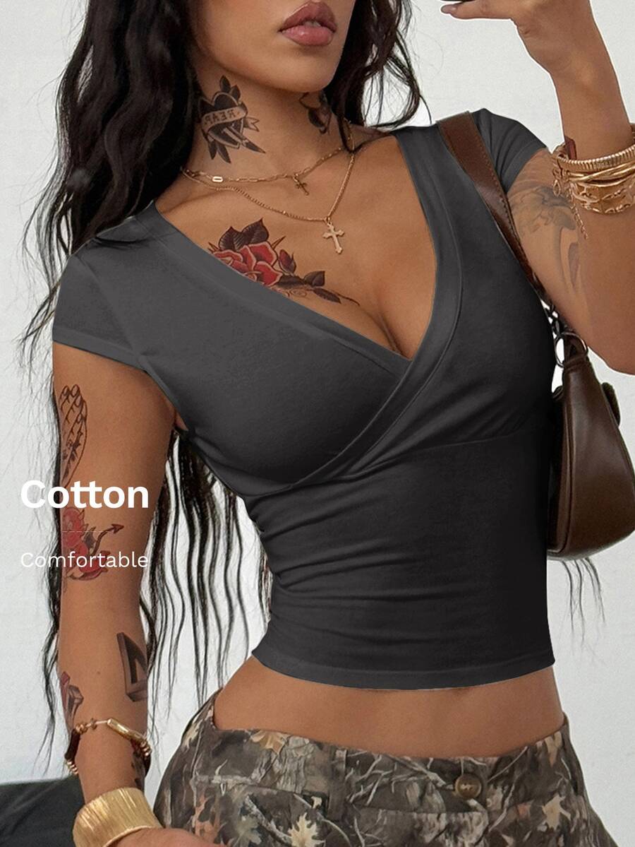 Women's slim fit V-neck short sleeve crop t-shirt featuring ruched wrap detailing in stretch knit fabric.