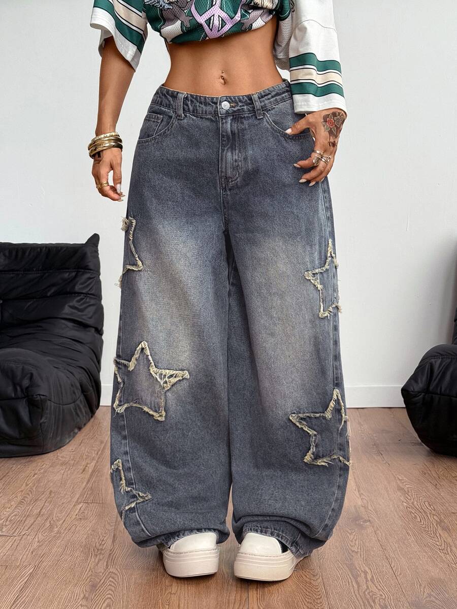 Women's loose fit baggy jeans in washed denim featuring star patches, slant pockets, and a mid-rise cut.