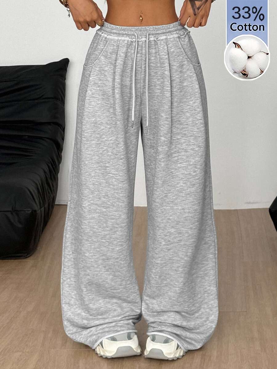 Women's casual straight leg baggy lounge pants in light grey with an adjustable drawstring waist and side pockets.