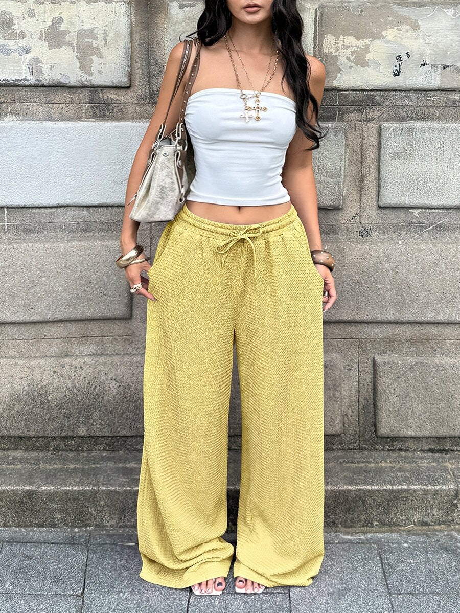 Women's loose fit straight leg lounge pants in textured knit fabric featuring an elastic drawstring waist and side pockets