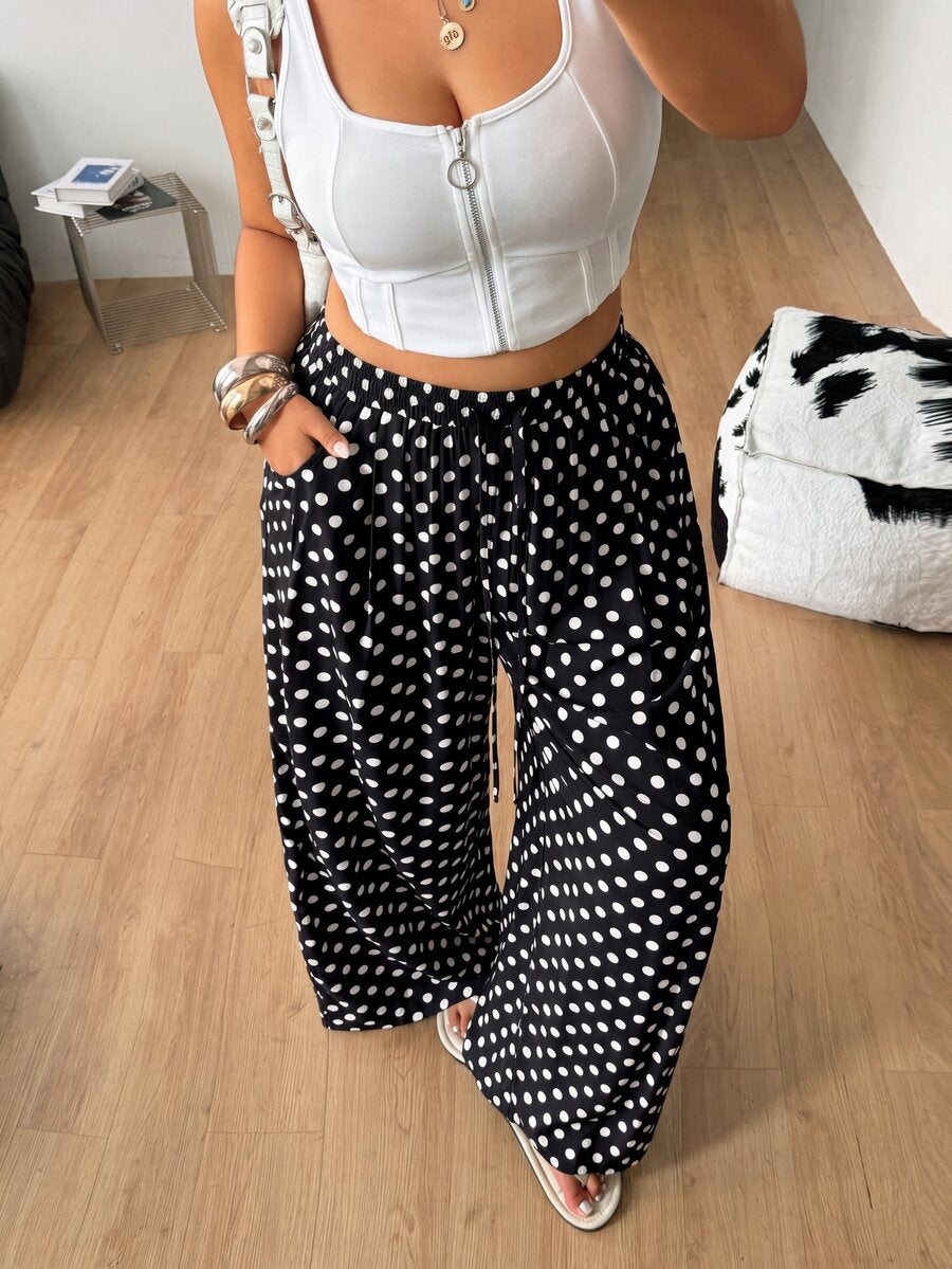 Plus size women's striped loose straight leg cropped pants with pleated detailing and side pockets