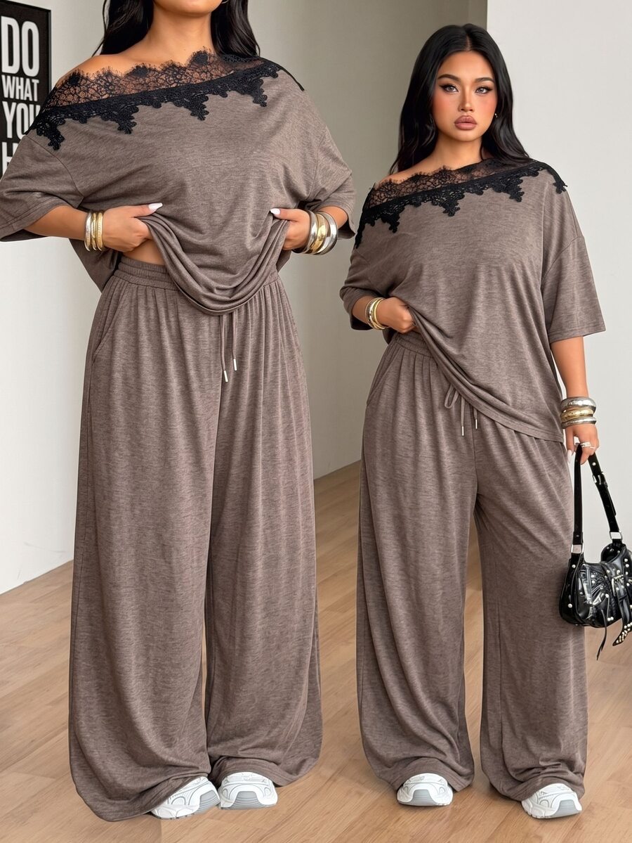 Women's casual two-piece outfit featuring a loose short-sleeve asymmetrical neck t-shirt and matching long wide leg pants with pockets.