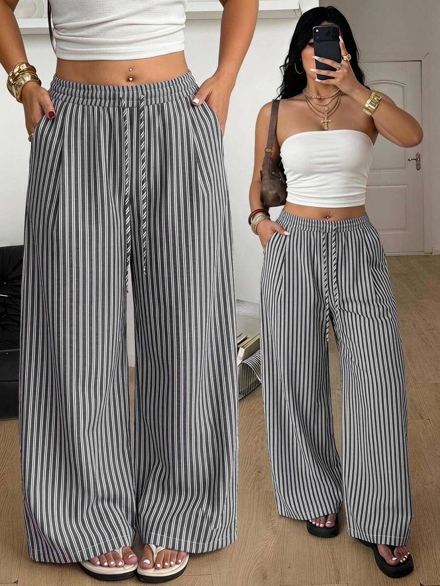Plus size women's striped loose straight leg cropped pants with pleated detailing and side pockets