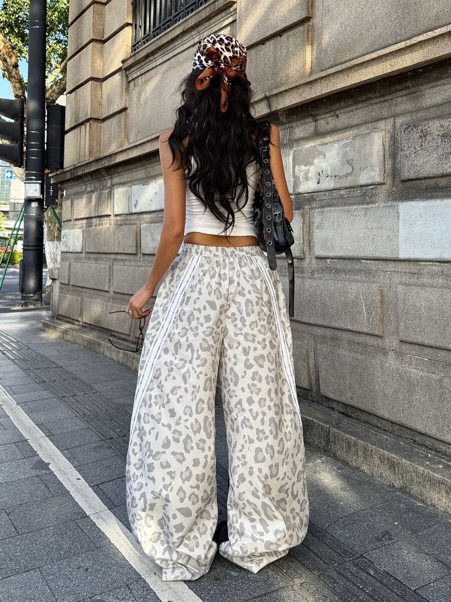 Women's loose fit straight leg pants in black and white with banded texture design, low drawstring waist, and pockets.
