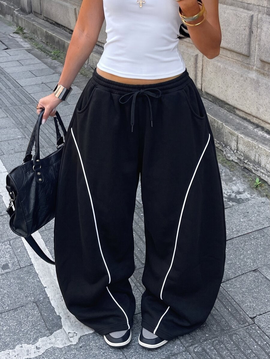 Women's casual grey plaid sweatpants featuring an elastic drawstring waistband, side pockets, and a relaxed loose fit.