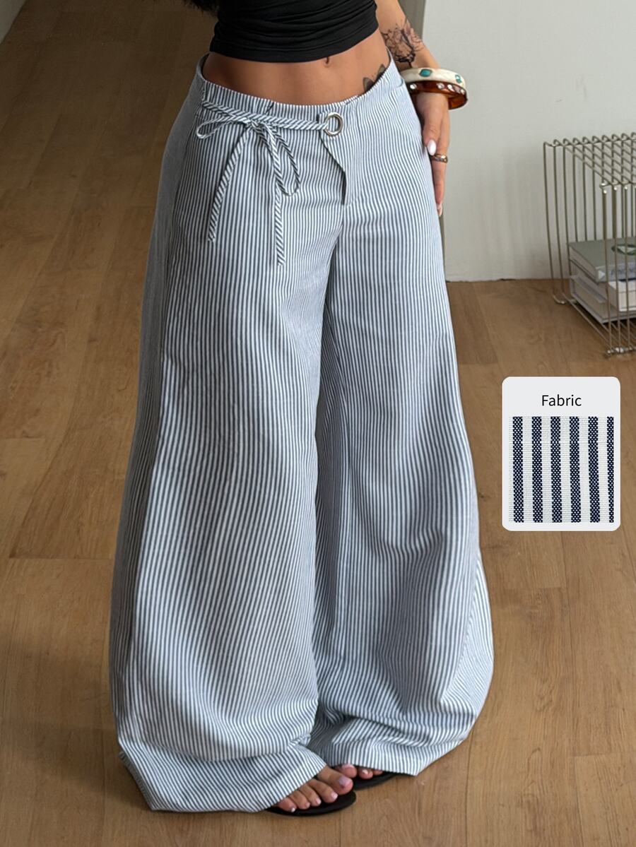 Women's blue and white striped woven wide leg long pants featuring side knot ties and grommet eyelet details.