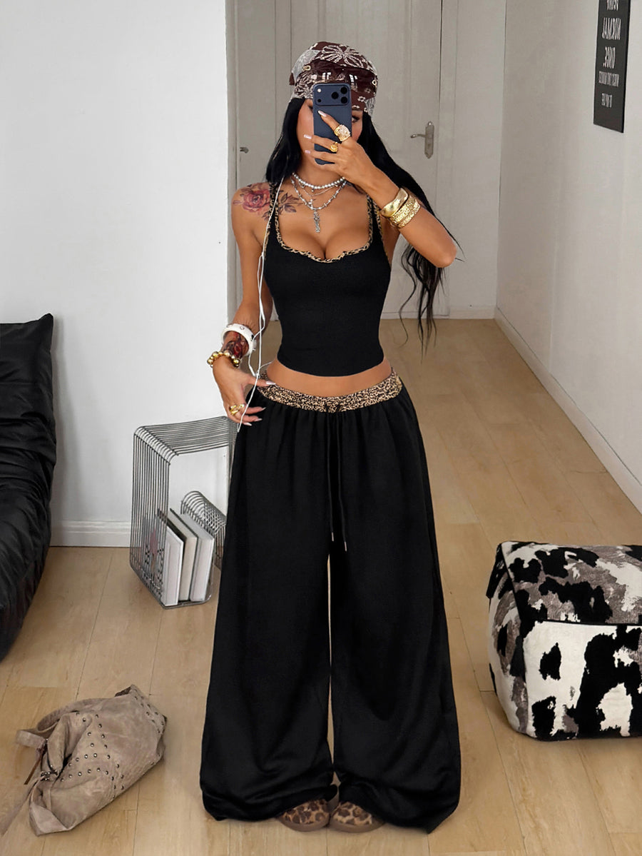 Women's two-piece casual outfit featuring a slim-fit camisole tank top with ruffle trim and button front paired with high-waisted wide leg pants.