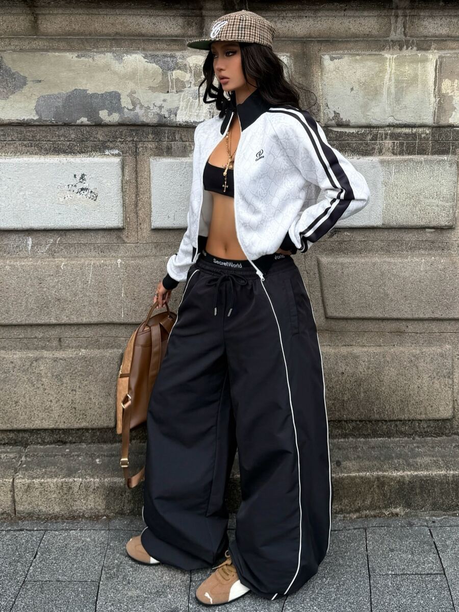 Women's loose fit straight leg pants in black and white with banded texture design, low drawstring waist, and pockets.