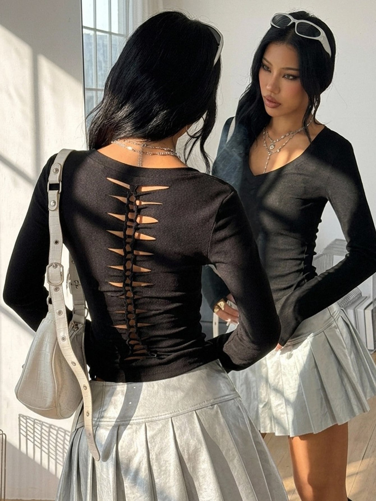 Women's fitted long sleeve rib-knit top featuring a deep V-neckline with delicate contrast lace detailing.
