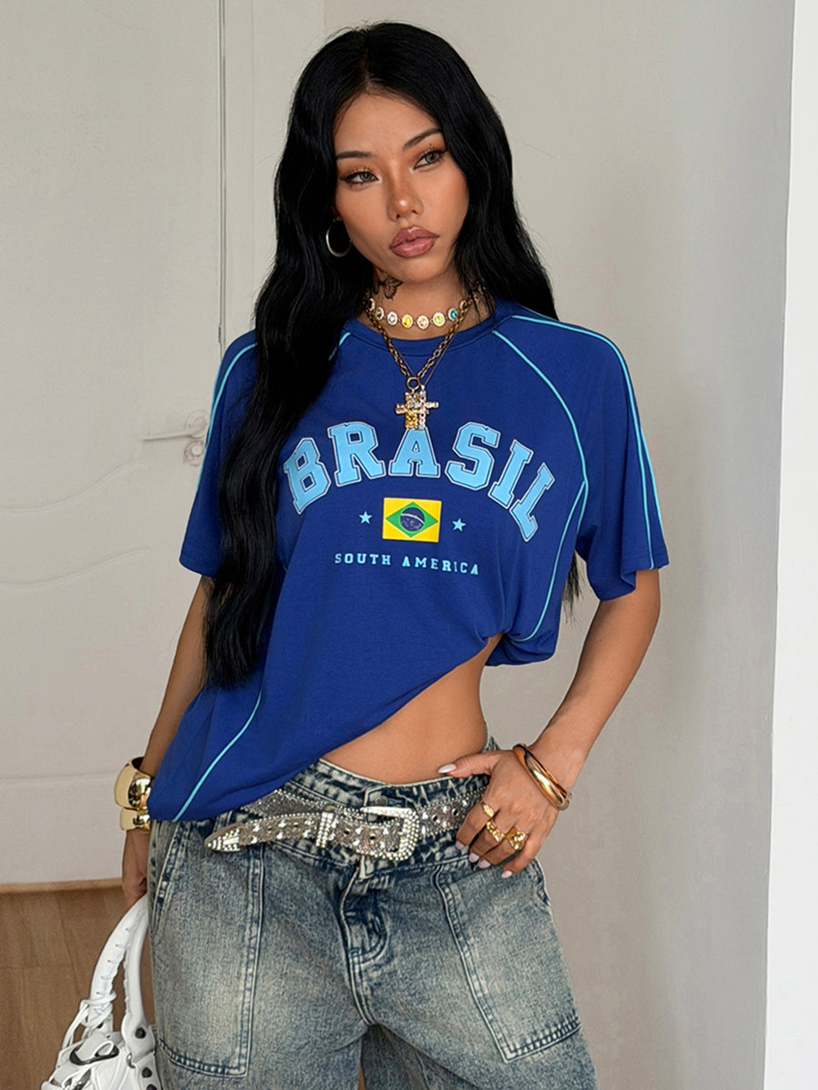 Yellow oversized graphic t-shirt featuring Brazil letter print on the front with contrast raglan sleeves and side stripe detailing.