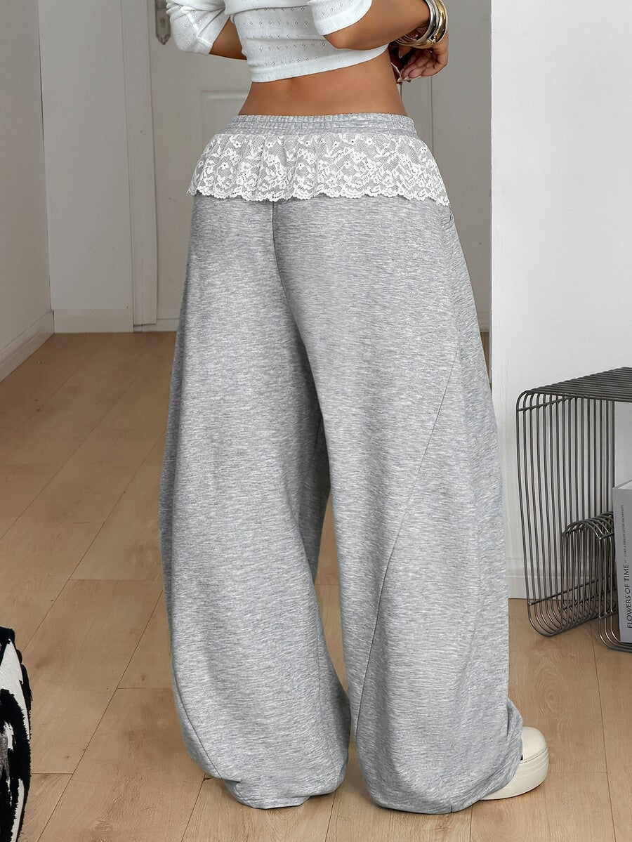 Women's casual grey plaid sweatpants featuring an elastic drawstring waistband, side pockets, and a relaxed loose fit.