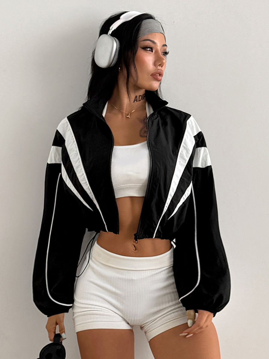 Black cropped lightweight sports jacket for women featuring colorblock stripes, a funnel neck, long sleeves, and a zipper closure.
