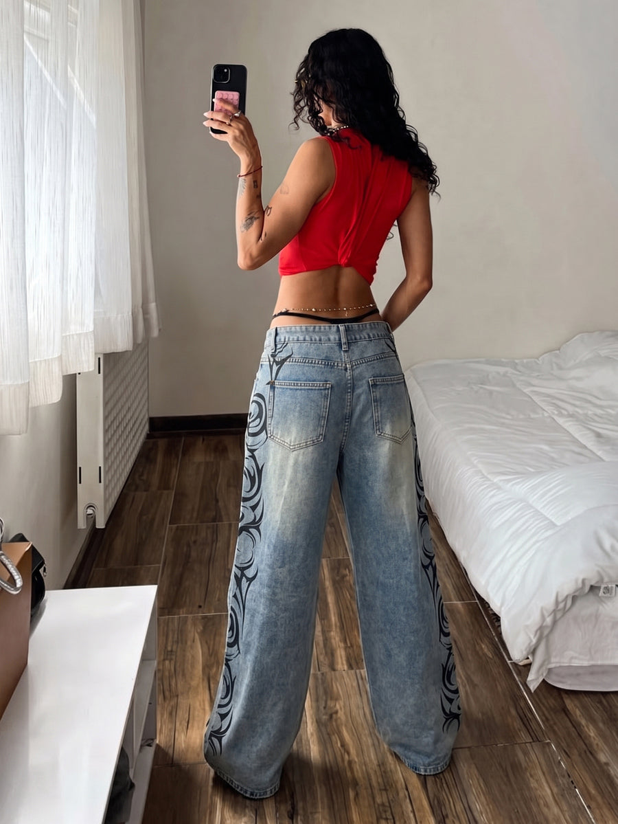 Front view of women's loose wide leg denim jeans featuring a mid waist, classic front pockets, and a zipper fly closure.