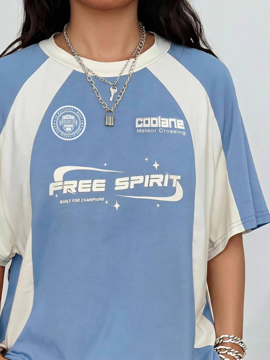 Unisex plus size oversized jersey t-shirt in brown featuring a round neck, short raglan sleeves with contrast binding, and a front letter graphic print.