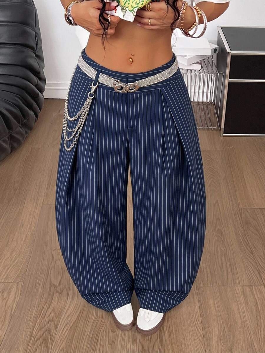Women's brown striped wide leg pants with a low waist, curved hem, and loose casual fit in woven fabric.