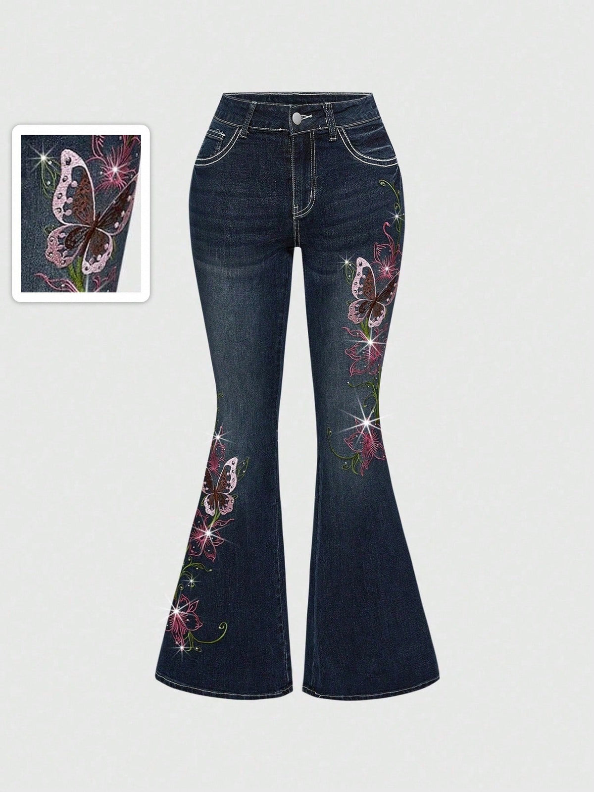 Women's blue ultra low waist flare jeans with butterfly vine embroidery and rhinestone detailing on stretch denim.