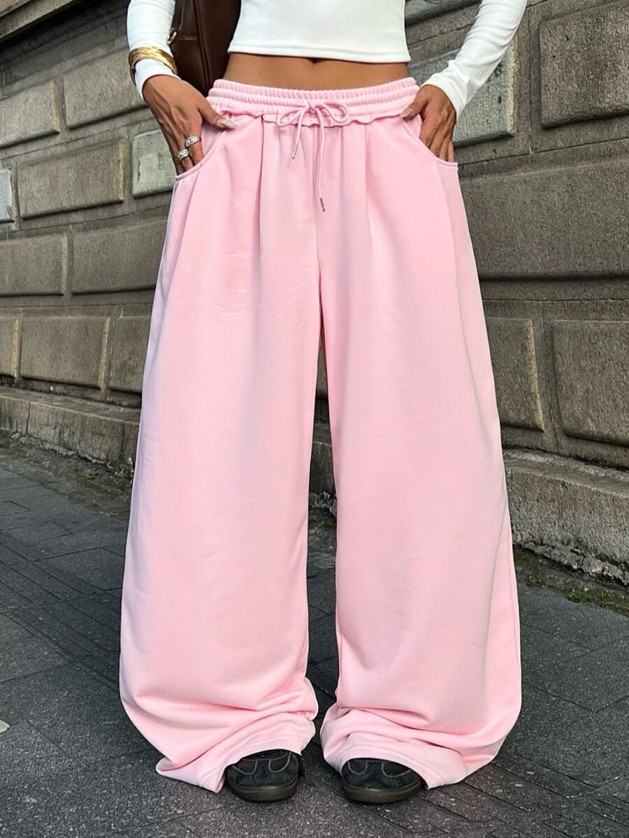Women's casual straight leg baggy lounge pants in light grey with an adjustable drawstring waist and side pockets.