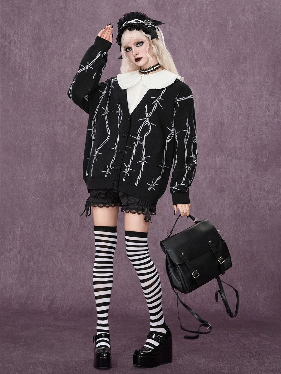 Women's oversized gothic thorn jacquard knit cardigan with V-neckline, button-front closure, and long drop-shoulder sleeves.