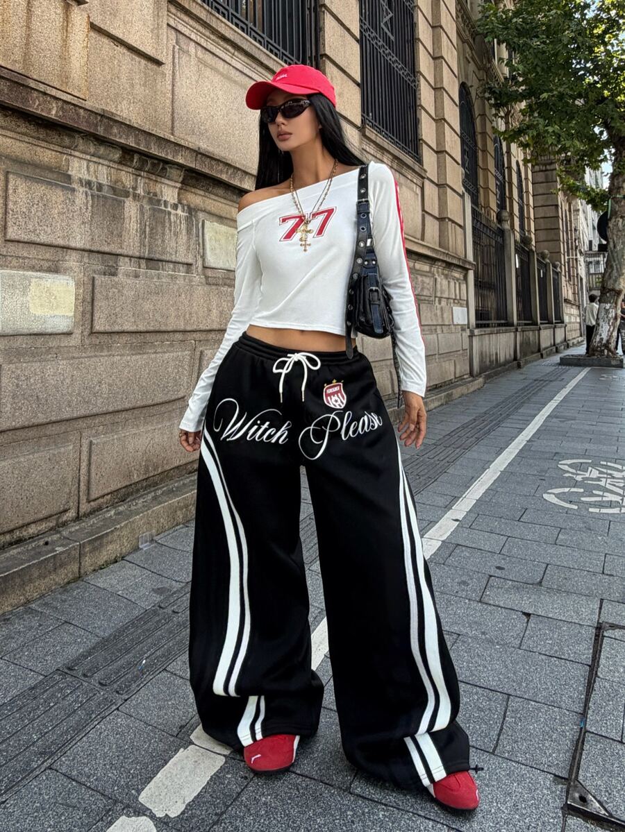 Women's loose fit wide leg graphic sweatpants in light grey with an elastic drawstring waistband