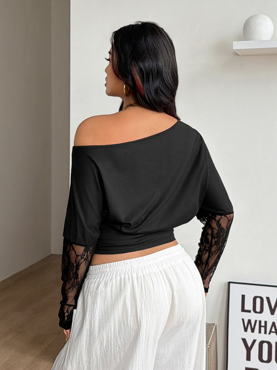 Women's black asymmetrical neck t-shirt featuring batwing sleeves and a slim fit knitted design.